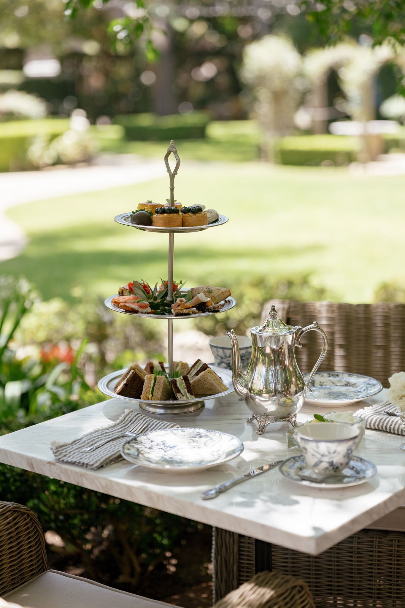 A three-tiered afternoon tea service in the gardens of the Simpson House Inn