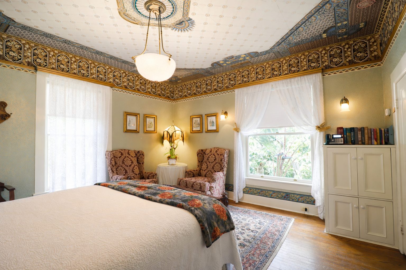The queen bed and garden view in the Margaret Simpson Room