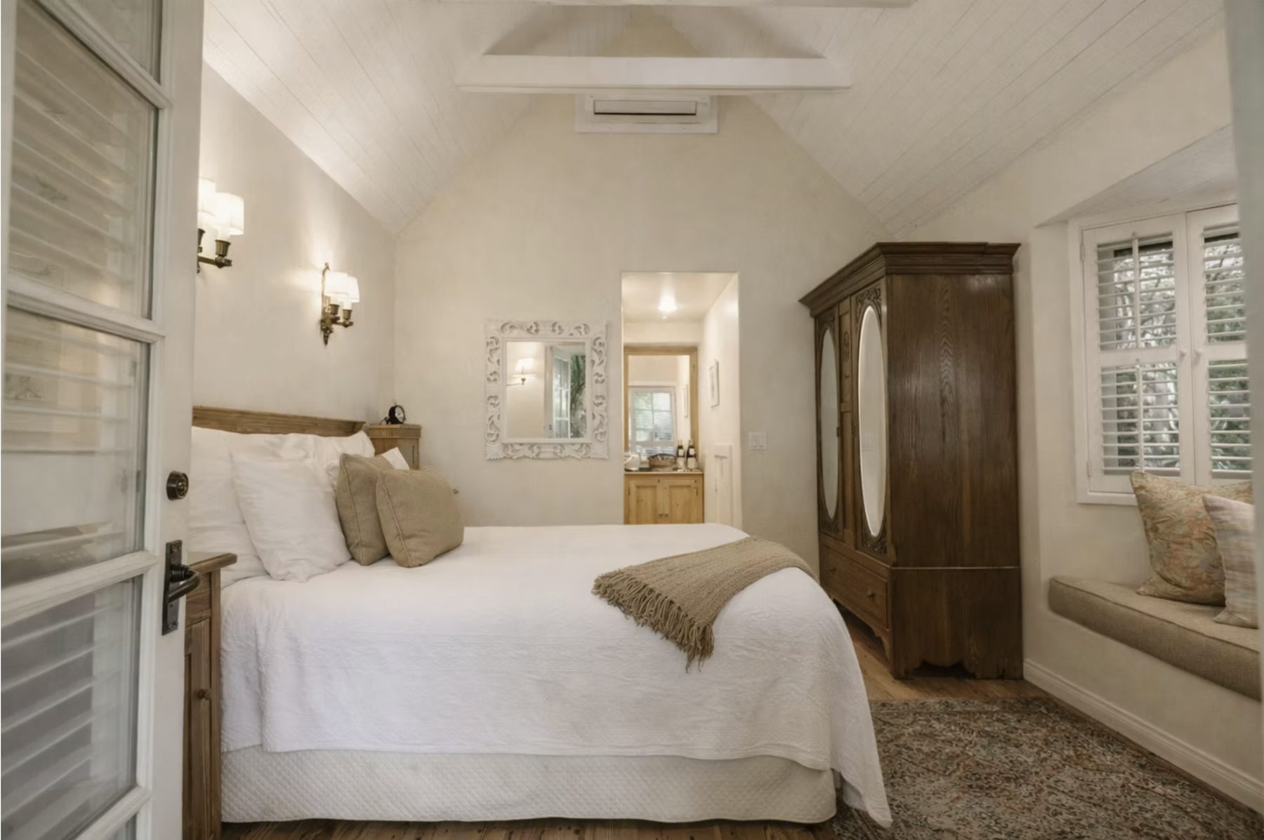 The queen bed beneath the vaulted ceiling of Garden Bungalow